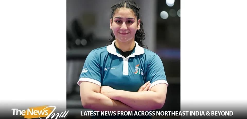 Athlete posing with arms crossed, wearing sports uniform