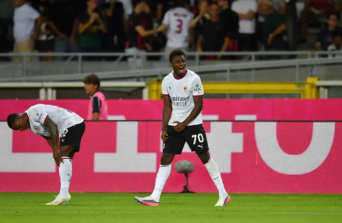 AC Milan players celebrating a goal on the pitch AC Milan players celebrating a goal on the pitch