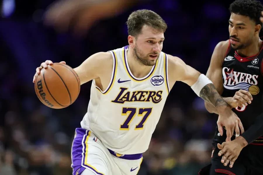 Lakers player dribbling past defender during game