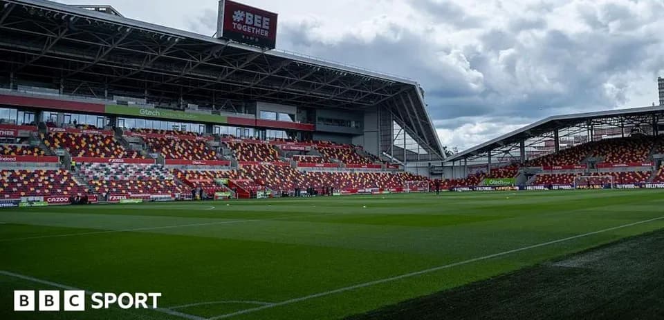 Brentford Community Stadium with empty stands and green pitch