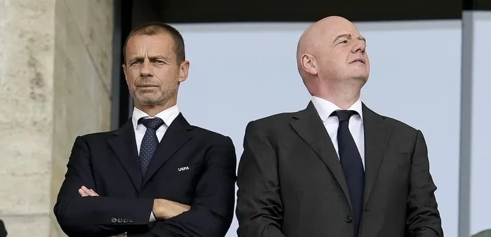Two officials observing an event from a balcony