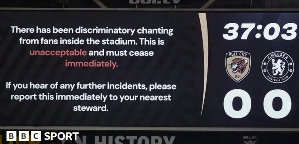 Stadium screen displaying message about fan behavior
