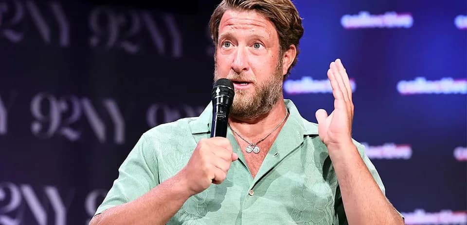 Speaker discussing on stage with microphone in hand