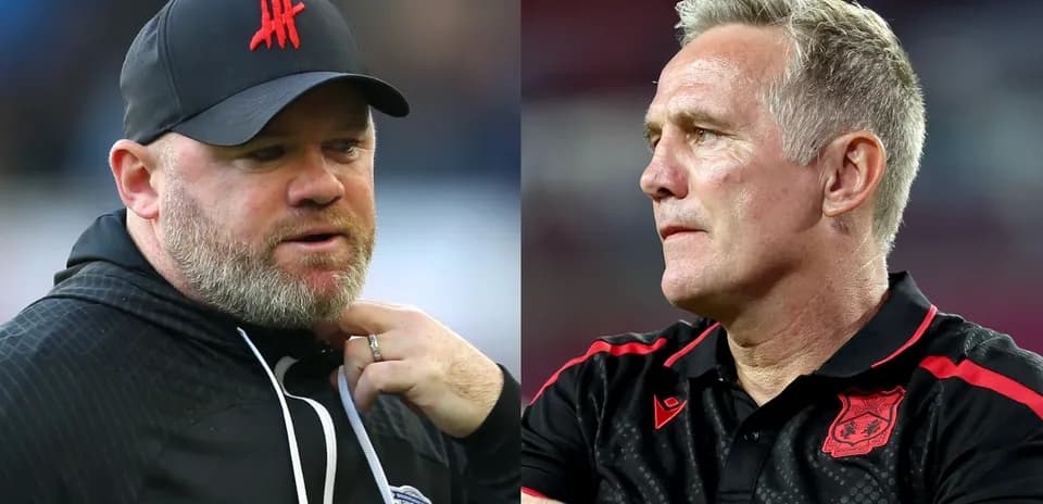 Two football managers discussing during match preparations