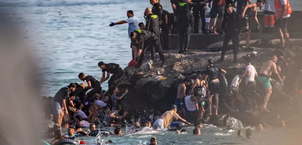 People gathered near rocky shore in water