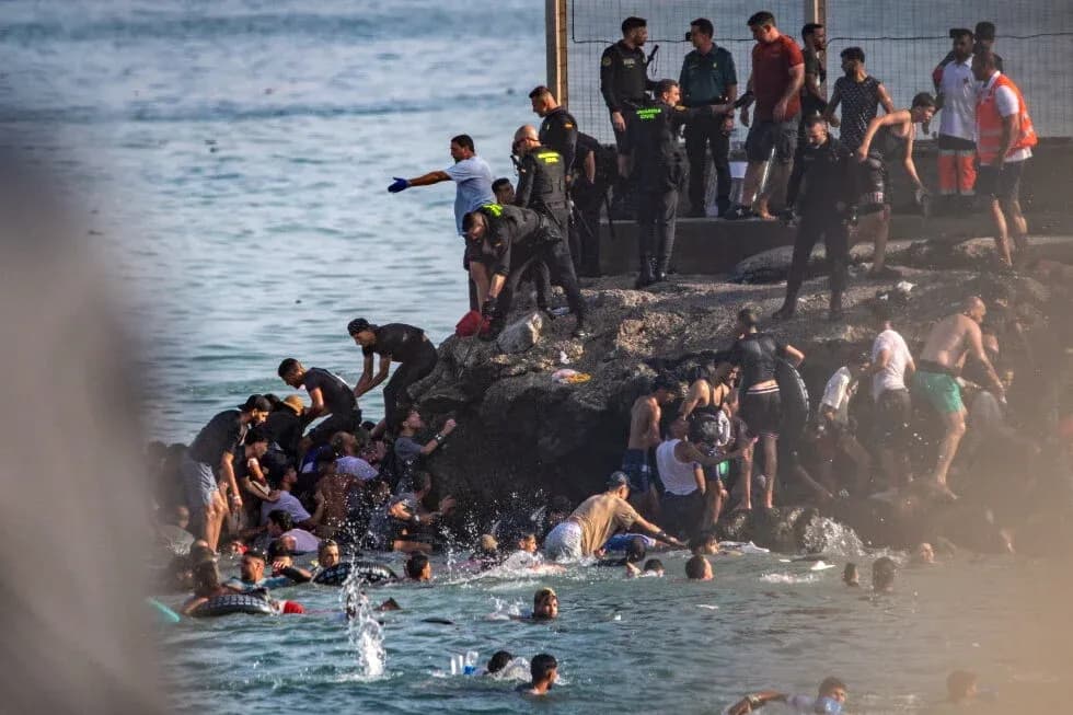 People gathered near rocky shore in water