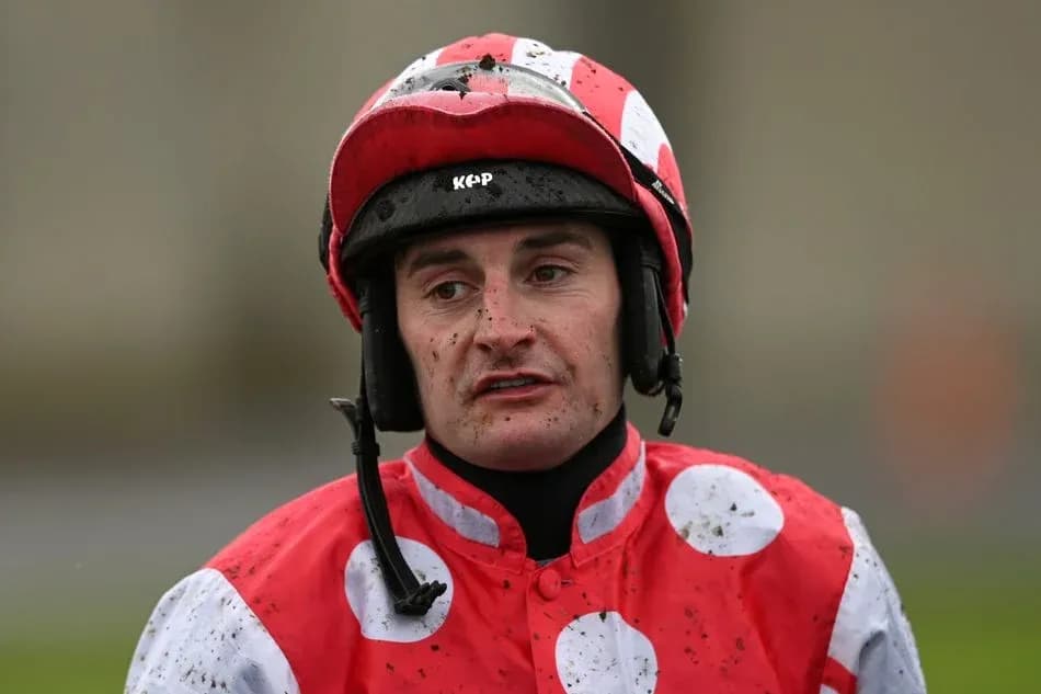 Jockey wearing red and white uniform after race