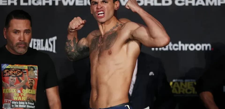 Boxer flexing muscles at weigh-in event