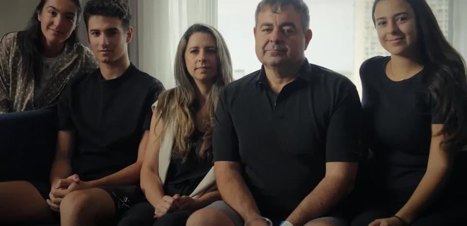 Five people sitting together on a couch
