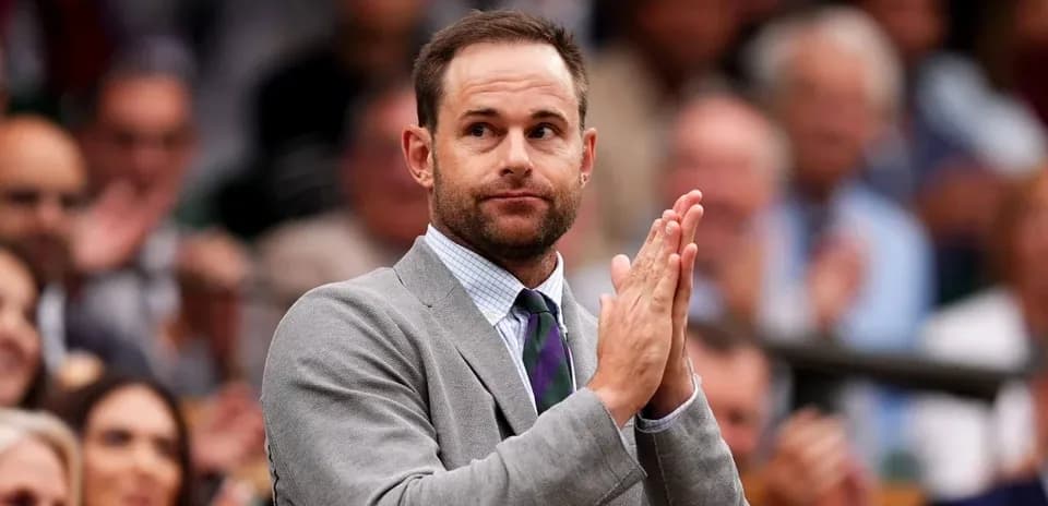 Man in suit applauding in crowded venue