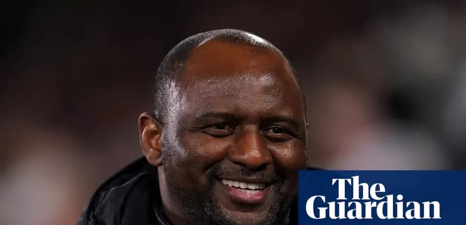 Football manager smiling during match observation