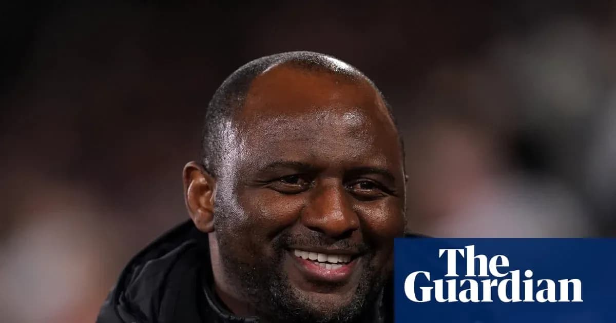 Football manager smiling during match observation