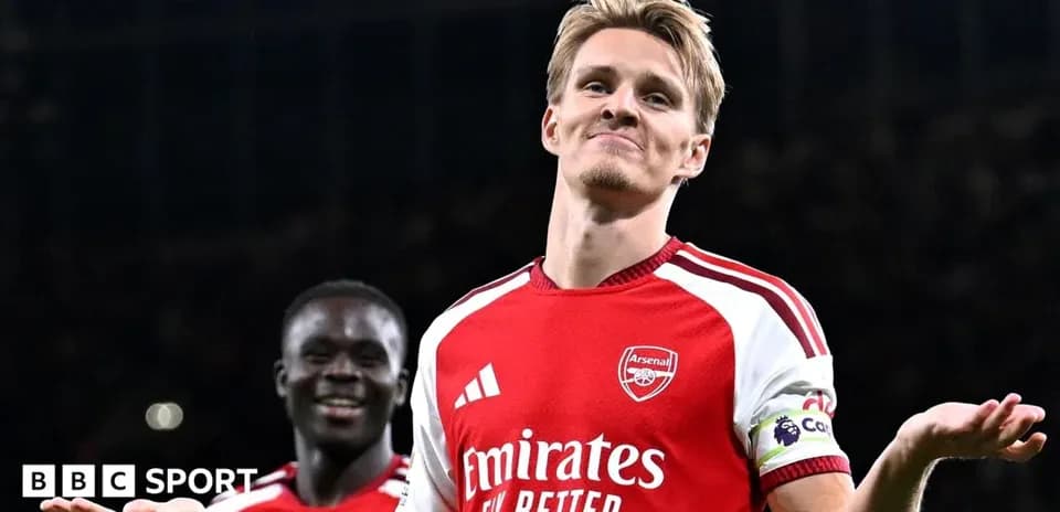 Arsenal player celebrating with teammate after match