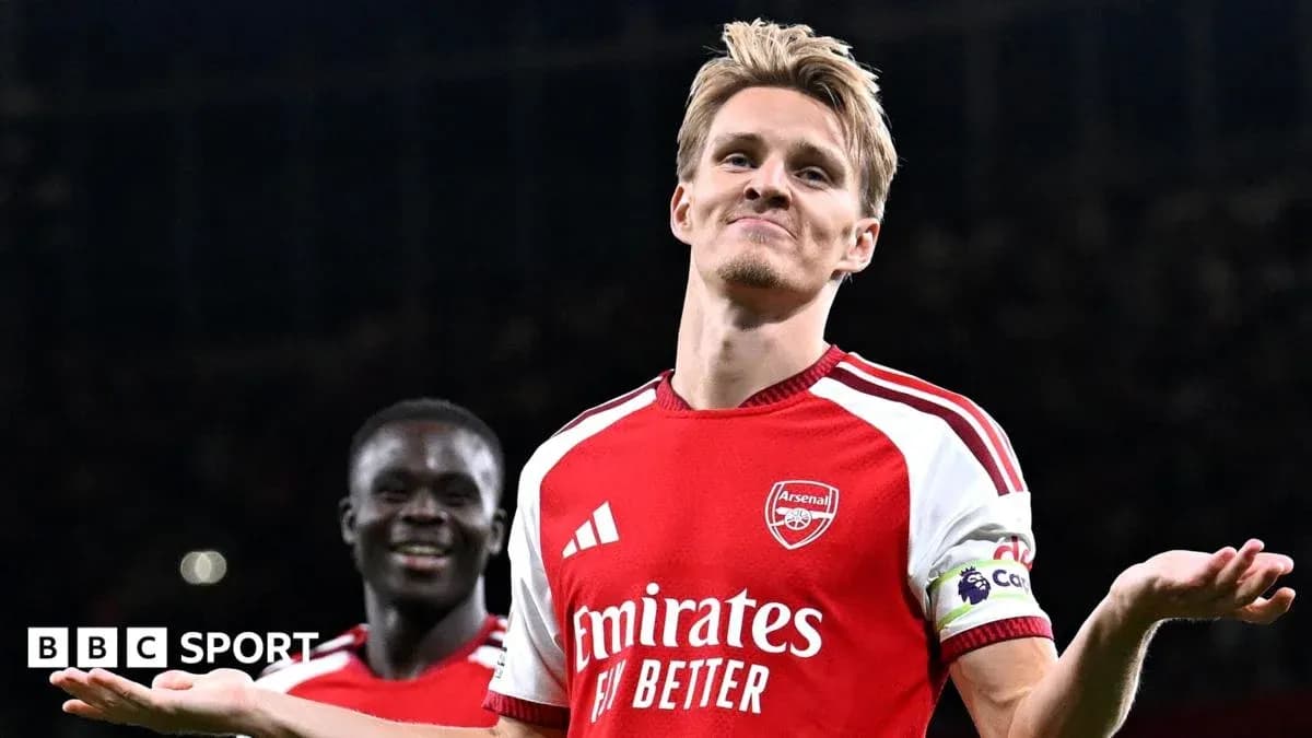 Arsenal player celebrating with teammate after match