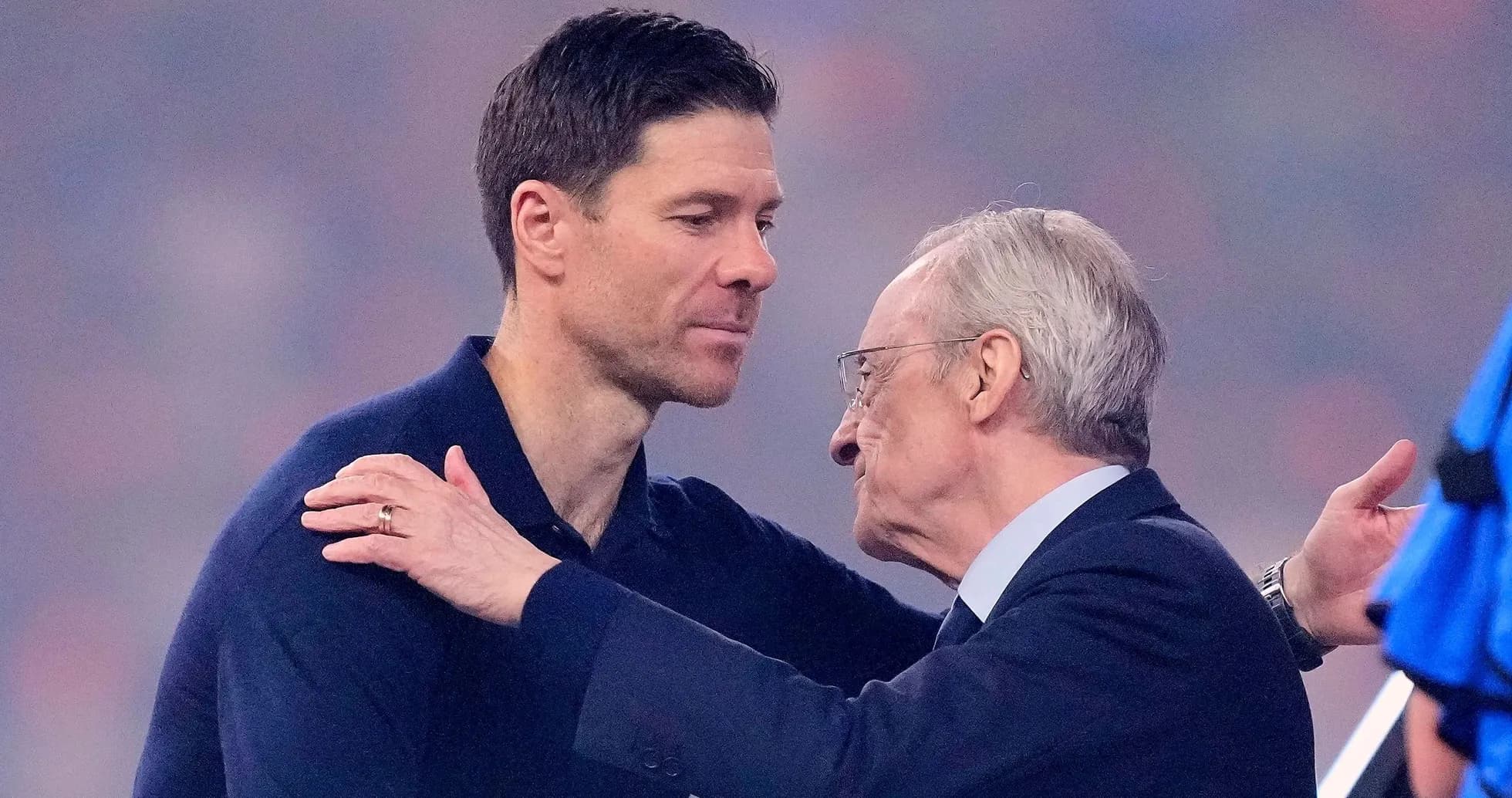 Xabi Alonso and Florentino Pérez embracing after match