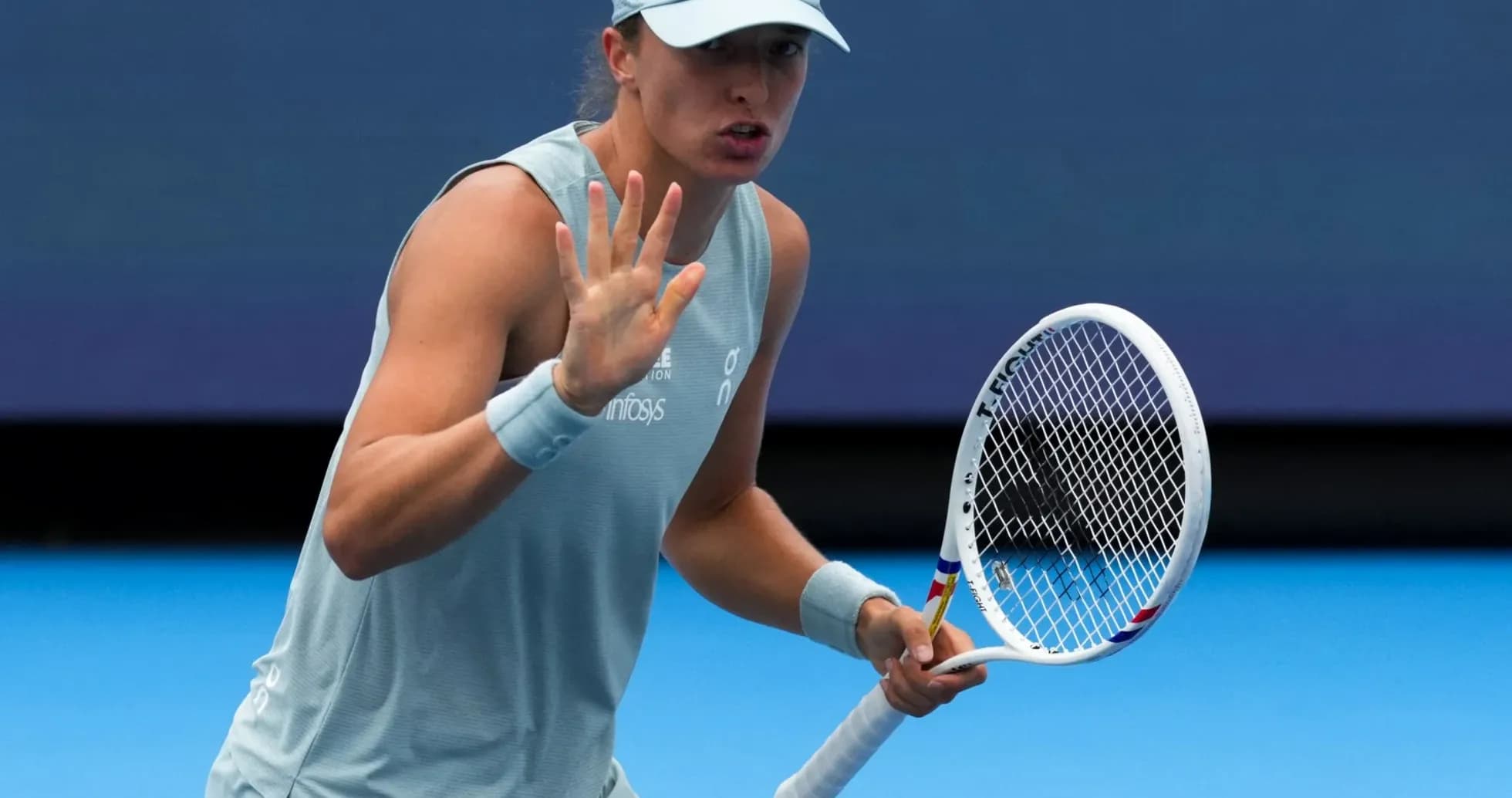 Tennis player gesturing during a match on court