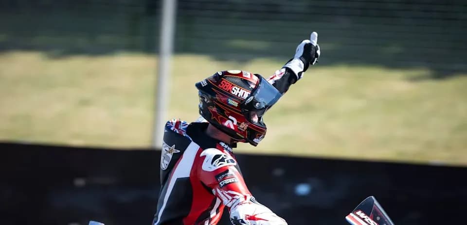 Motorsport racer celebrating with raised hand
