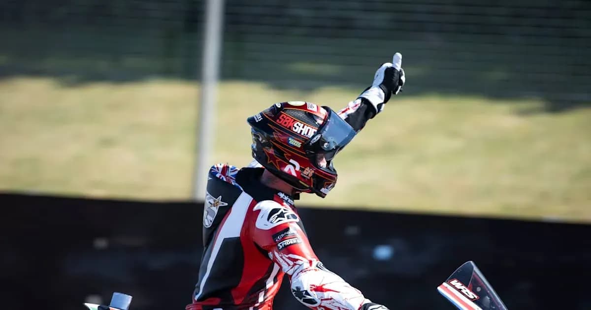 Motorsport racer celebrating with raised hand