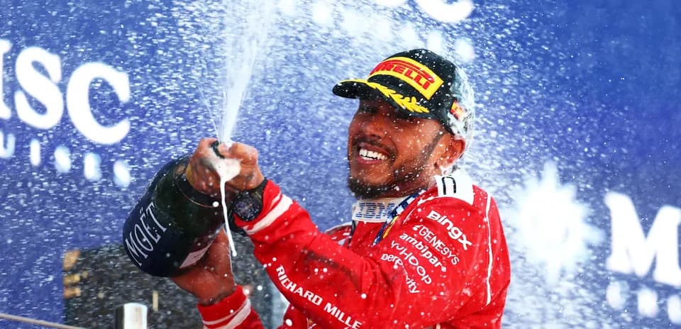 Driver spraying champagne on podium celebration