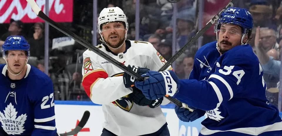 Hockey players battling for puck during match