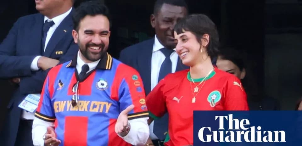 Two fans in team jerseys smiling at event