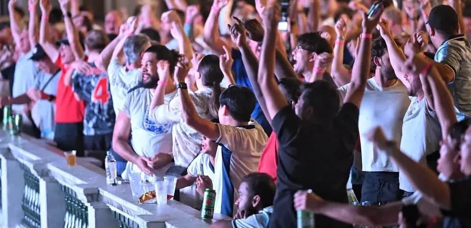 Fans celebrating and cheering at a sports event