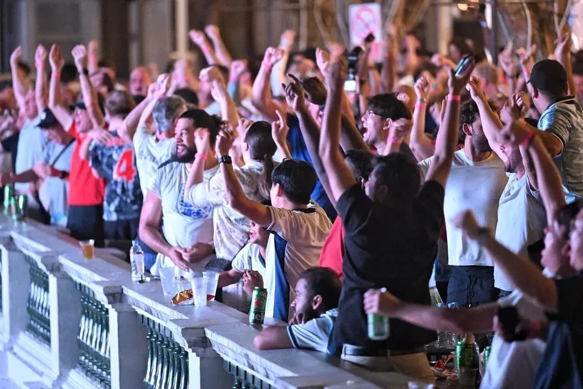 Fans celebrating and cheering at a sports event