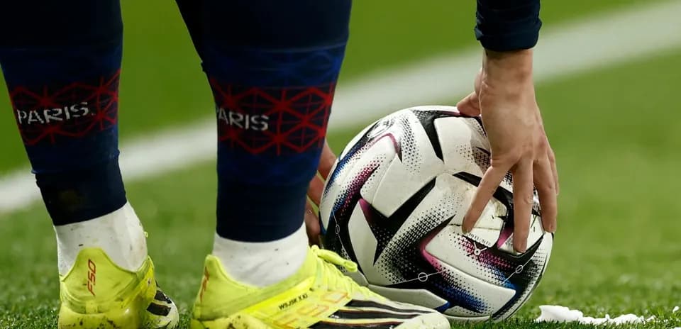 Player preparing to kick ball on field