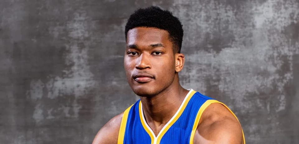 Basketball player in blue jersey posing for photo