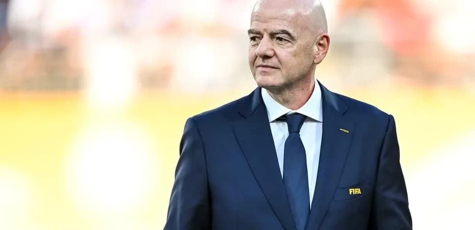 FIFA president walking on the pitch before match