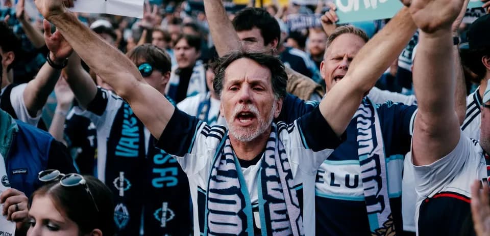 Vancouver Whitecaps fans cheering with signs