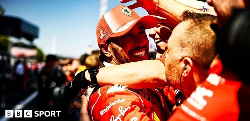 Ferrari team celebrating victory with driver in red uniform