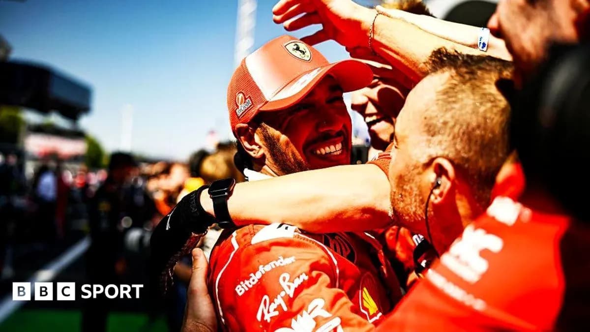 Ferrari team celebrating victory with driver in red uniform