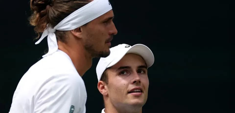 Tennis players discussing during match on court