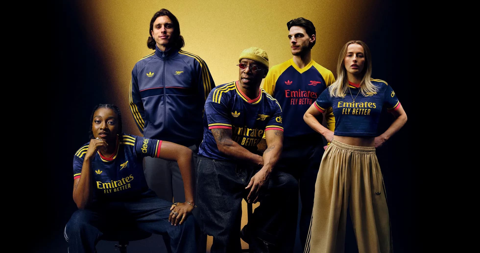 Five people posing in Arsenal jerseys and outfits