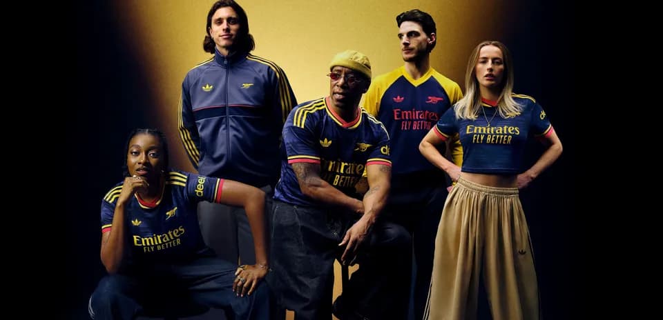Five people posing in Arsenal jerseys and outfits