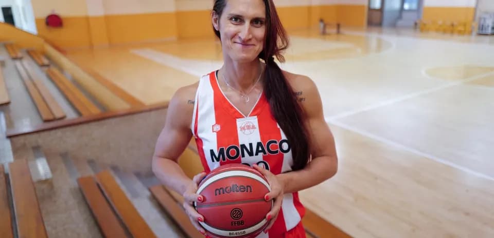 Basketball player holding ball in gym