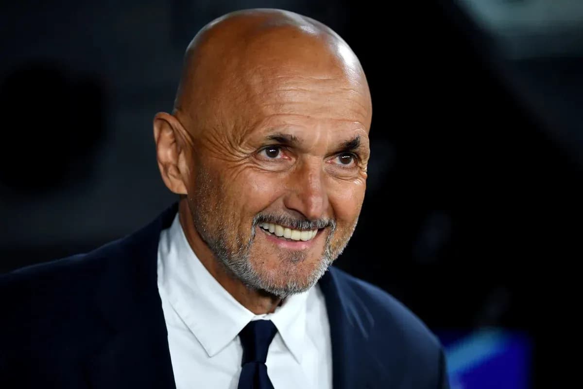 Bald man smiling in a dark setting