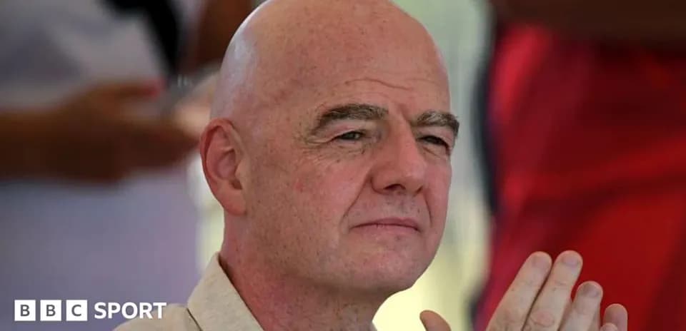 Man with bald head and hands clasped together