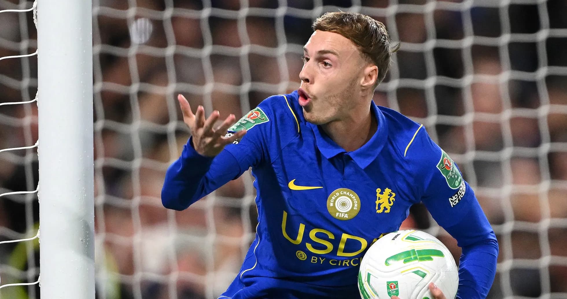 Futbolchi to'pni ushlab, jamoasiga ko'rsatma bermoqda