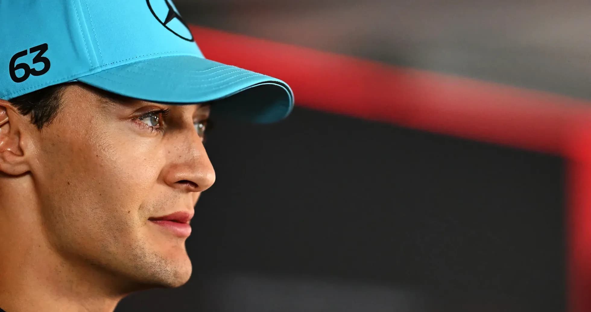 Racing driver wearing a blue cap during event