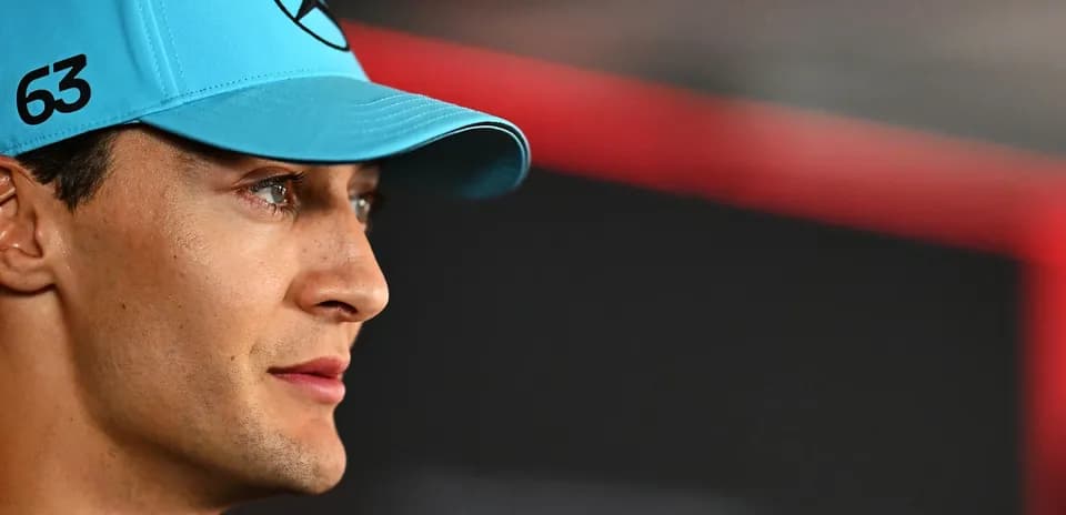Racing driver wearing a blue cap during event