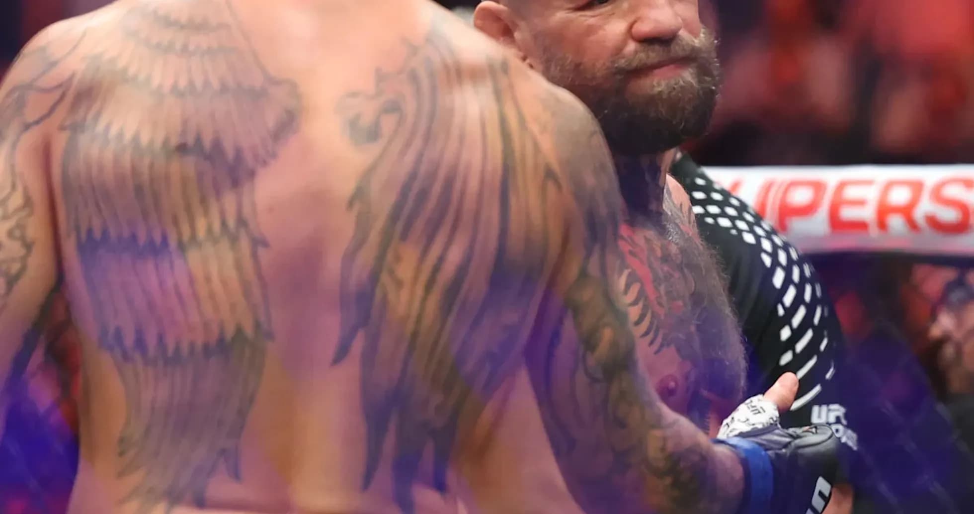 Two fighters interacting in the octagon after match