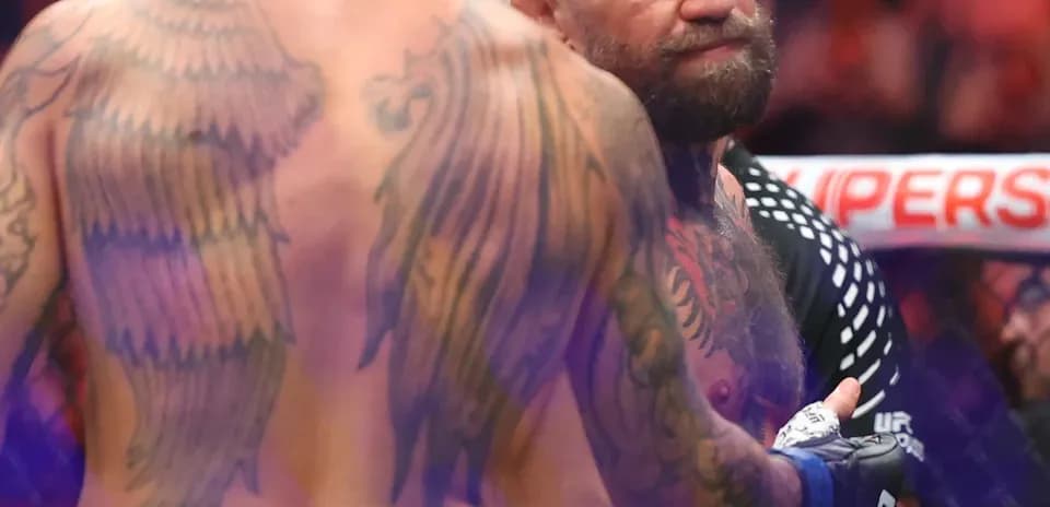 Two fighters interacting in the octagon after match