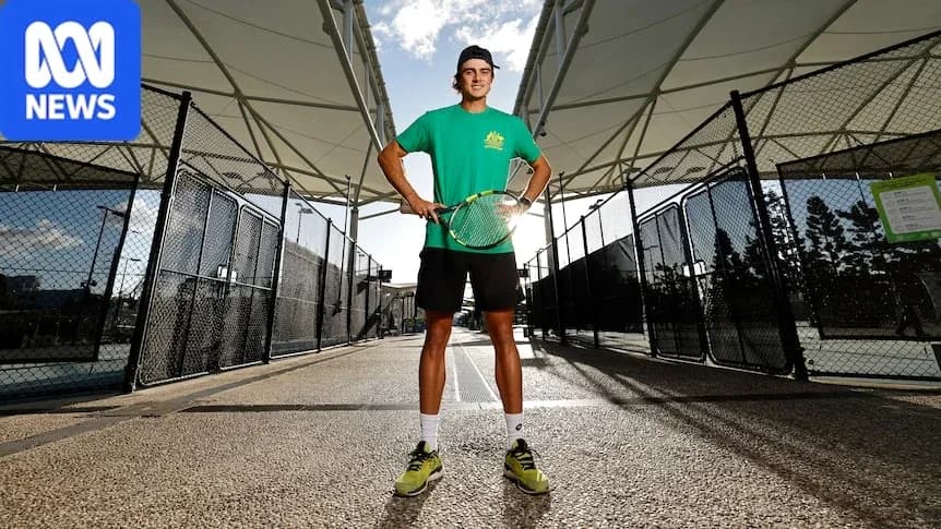 Tennis player posing with racket at court