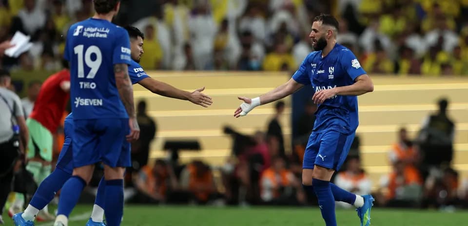 Players shaking hands after a match on the field