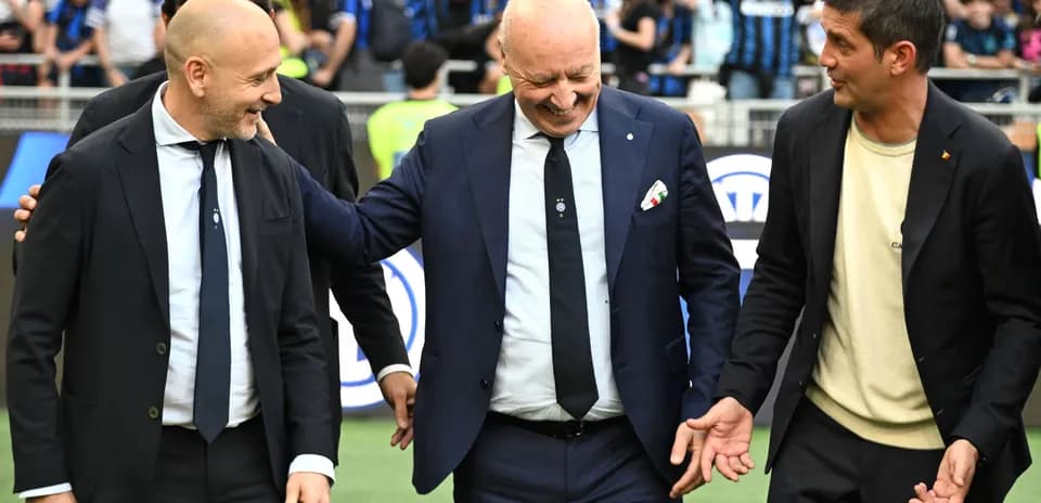 Coaches interacting on the pitch before a match