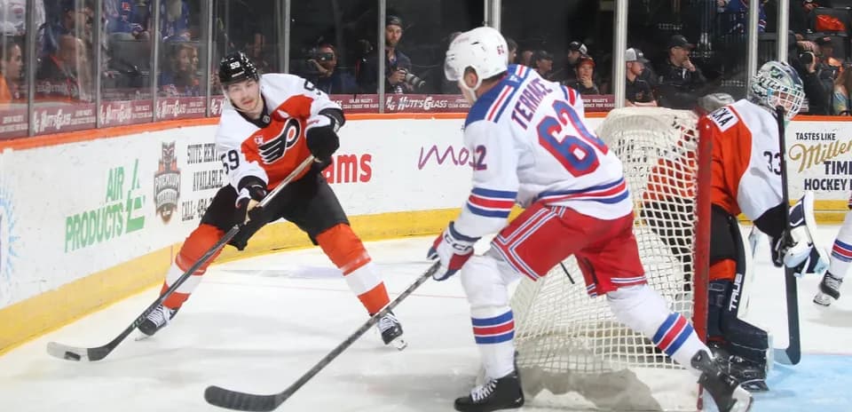 Philadelphia Flyers player skating with puck against Rangers