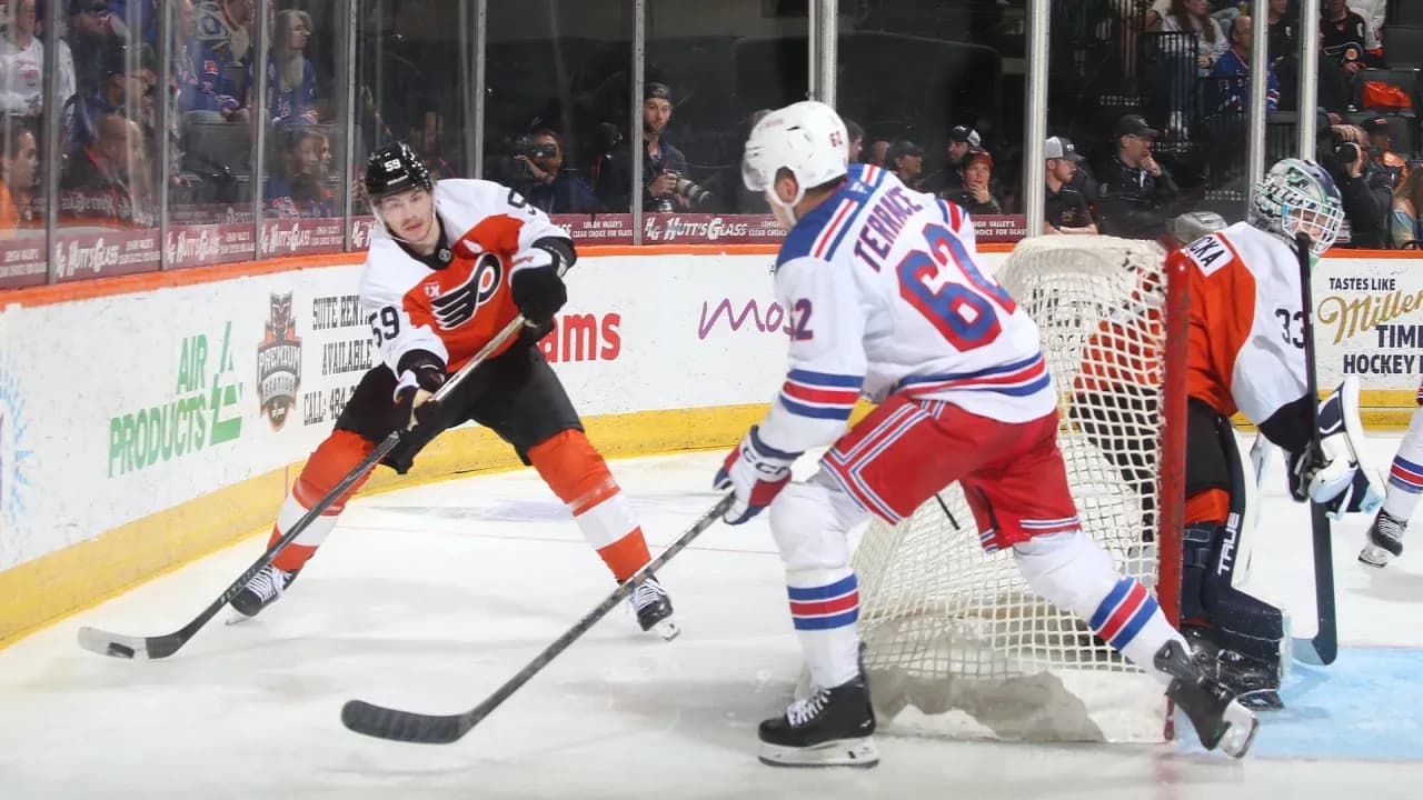 Philadelphia Flyers player skating with puck against Rangers