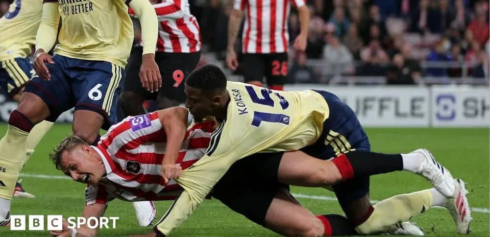 Players battling for possession during a football match